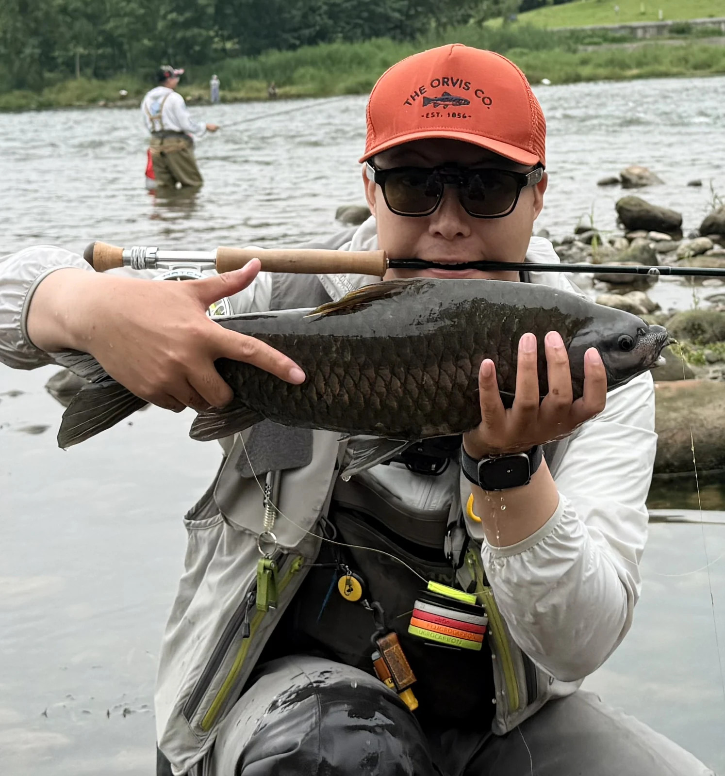 Zeo holding a catch in the river